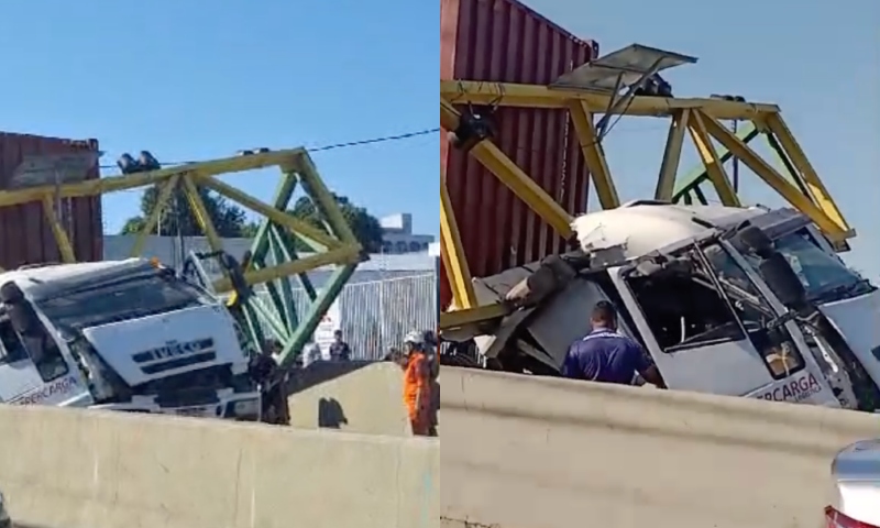 Carreta destrói limitador de altura de veículos e motorista fica preso às ferragens, em Manaus; veja vídeo